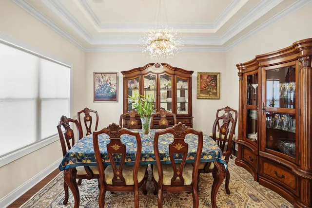 a view of a dining room with furniture and chandelier
