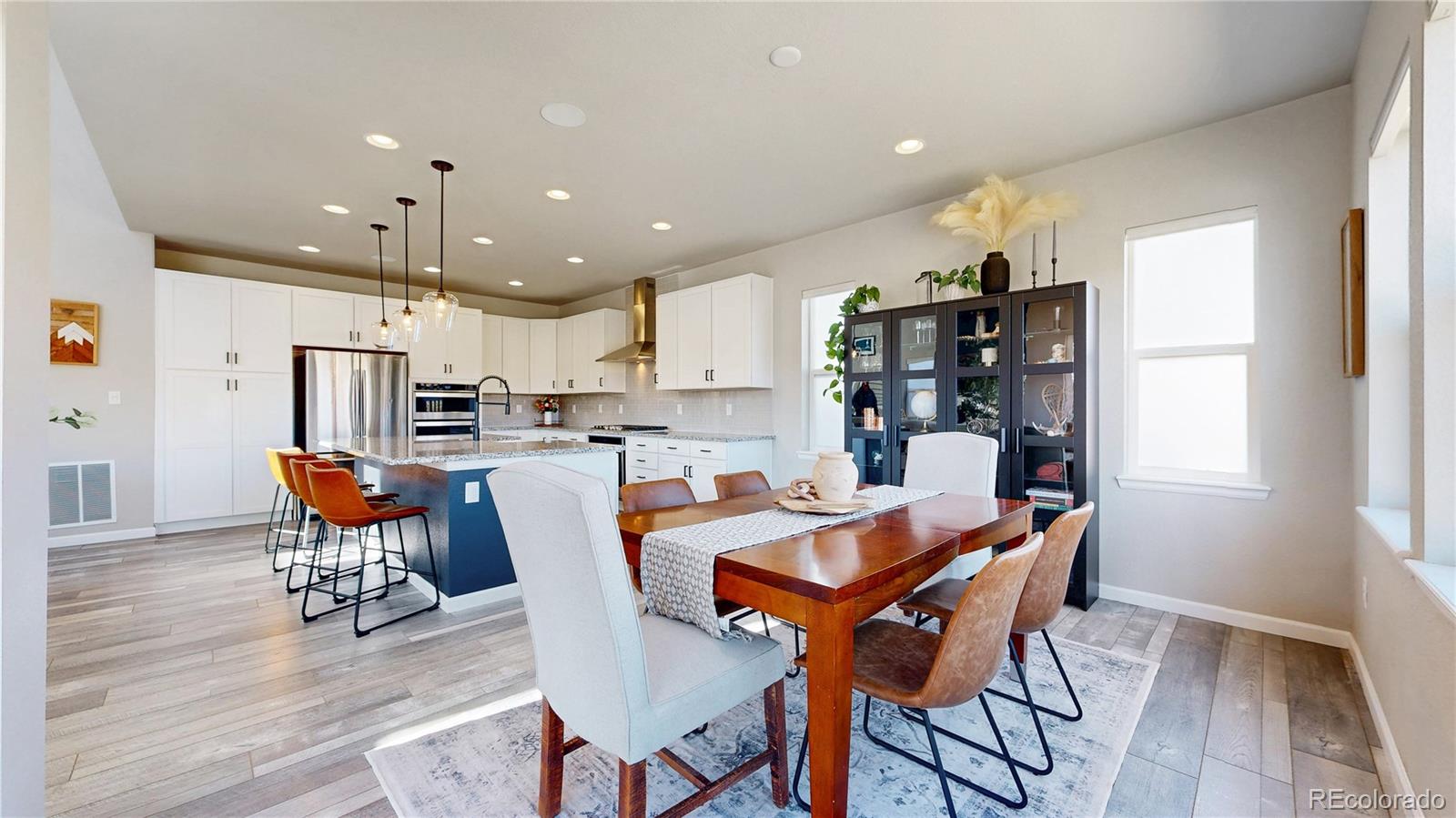 1107 Basalt Ridge Loop Castle Rock, CO 80108 - Photo 17 of 50 a dining room with stainless steel appliances a dining table chairs and a refrigerator