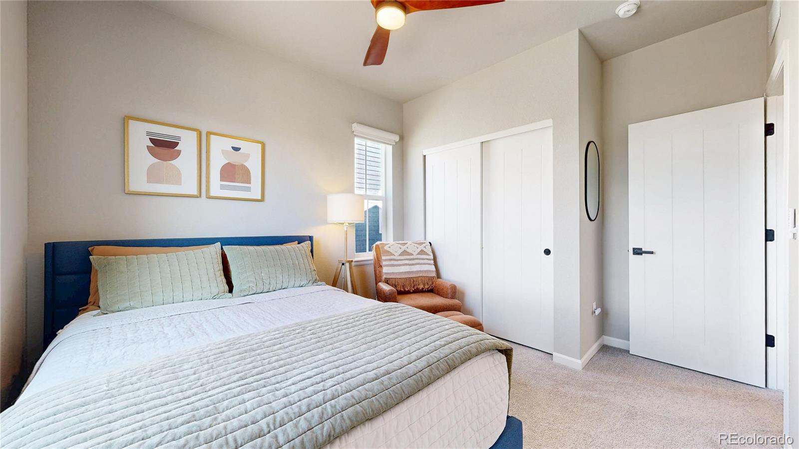 1107 Basalt Ridge Loop Castle Rock, CO 80108 - Photo 27 of 50 a bedroom with a large bed and a chandelier