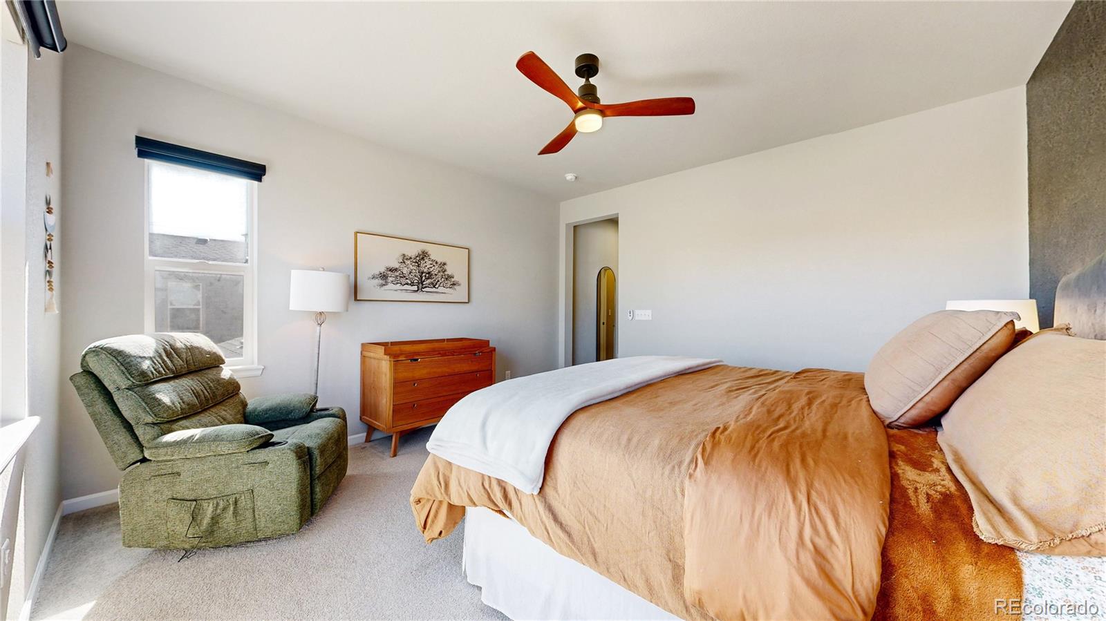 1107 Basalt Ridge Loop Castle Rock, CO 80108 - Photo 30 of 50 a bedroom with bed and a couch