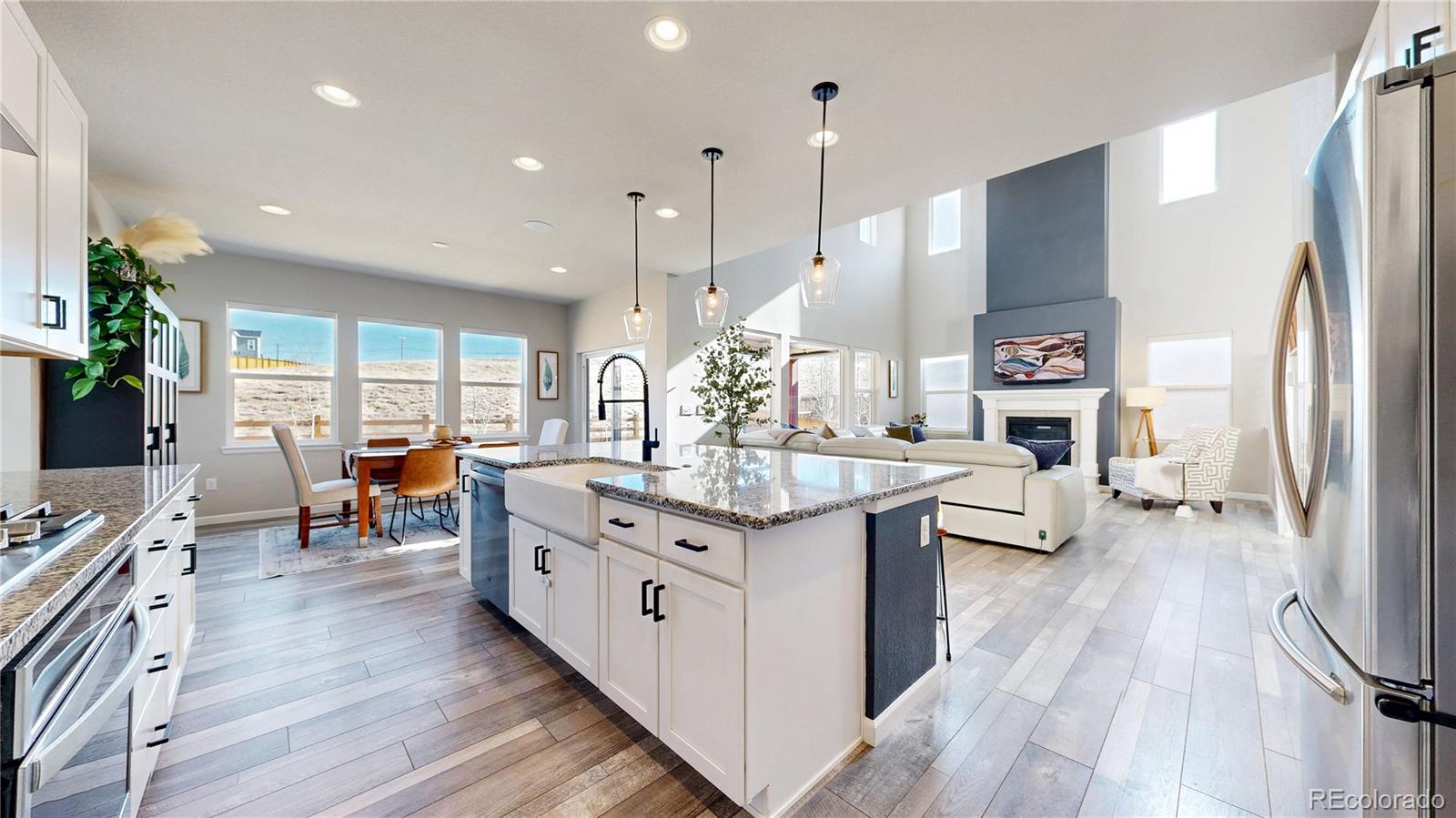 1107 Basalt Ridge Loop Castle Rock, CO 80108 - Photo 6 of 50 a kitchen with stainless steel appliances granite countertop a stove oven and a refrigerator
