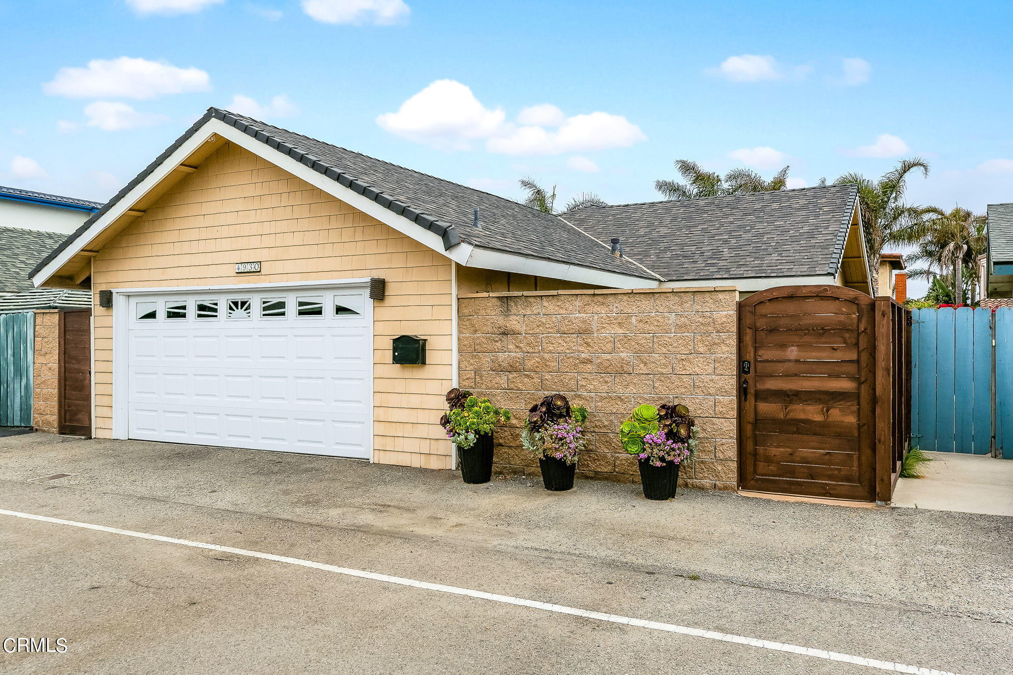 a view of a house with potted plants