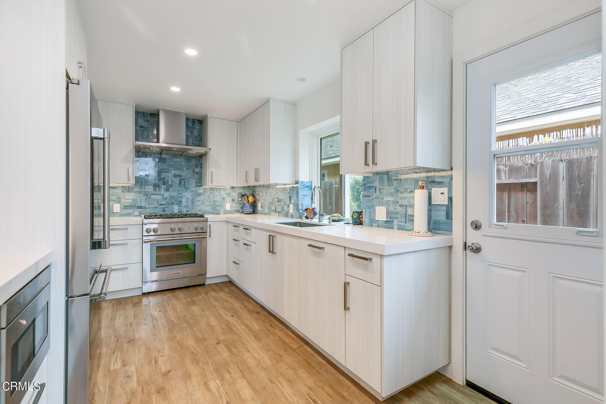 4930 Dolphin Way Oxnard, CA 93035 - Photo 13 of 44 a kitchen with a stove a sink and a refrigerator