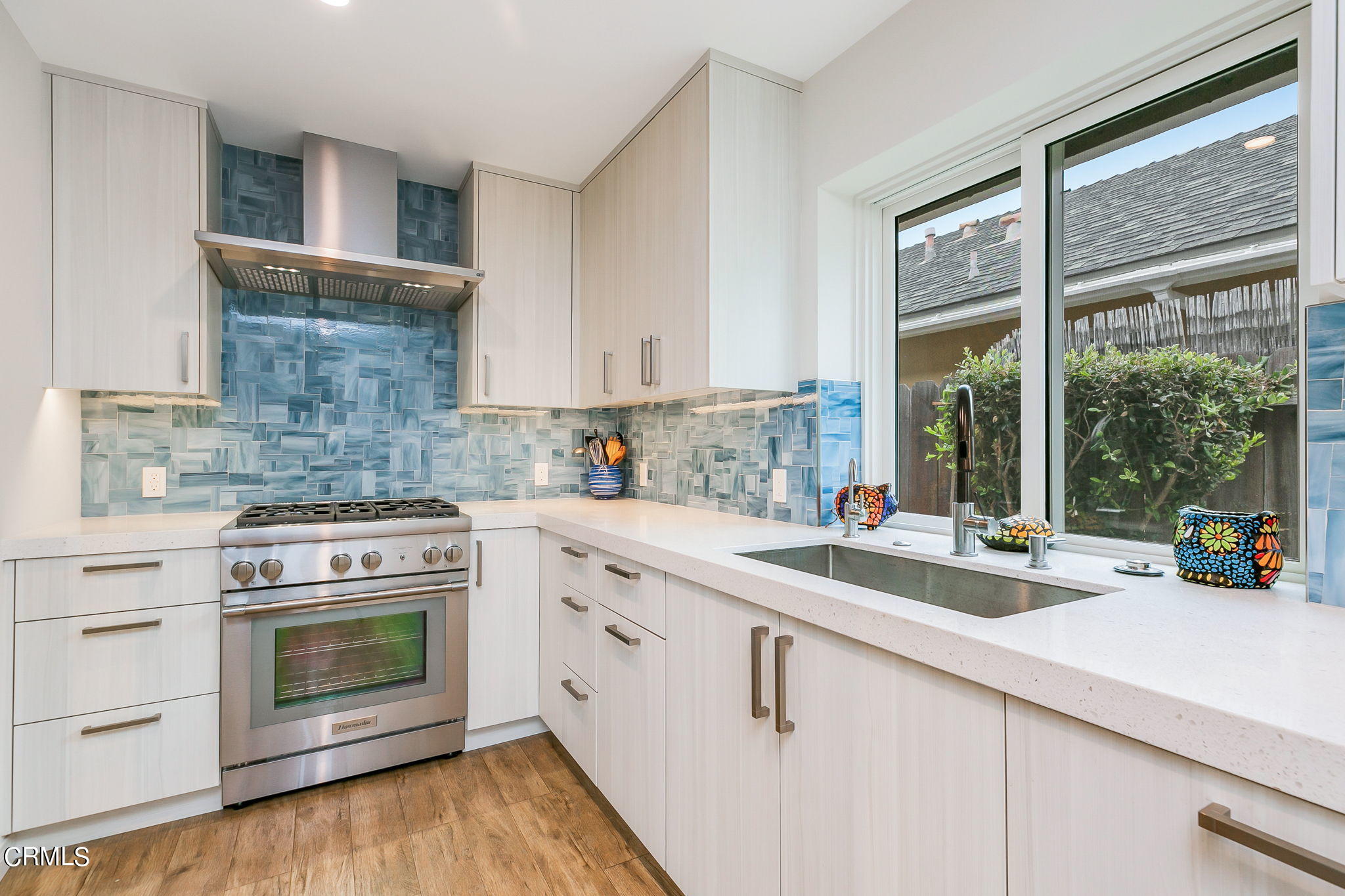 4930 Dolphin Way Oxnard, CA 93035 - Photo 15 of 44 a kitchen with cabinets appliances and a large window