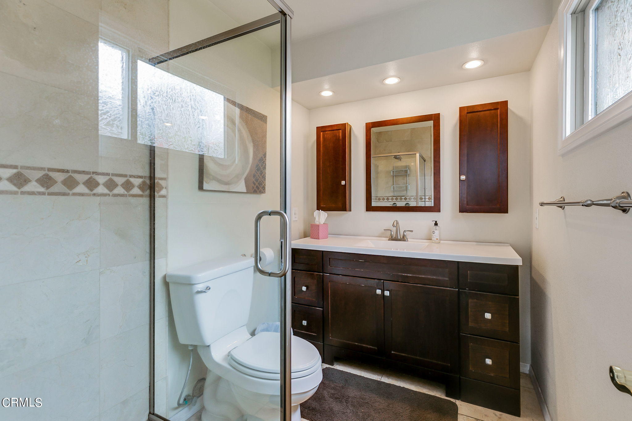 4930 Dolphin Way Oxnard, CA 93035 - Photo 21 of 44 a bathroom with a double vanity sink toilet and mirror