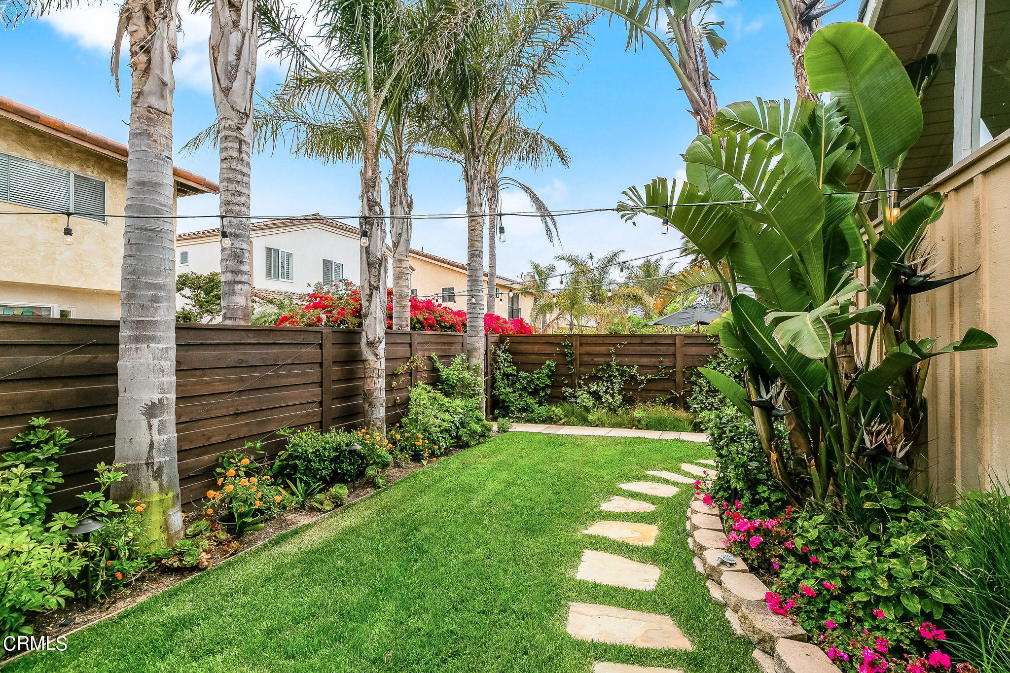 4930 Dolphin Way Oxnard, CA 93035 - Photo 30 of 44 a front view of a house with a yard and fountain