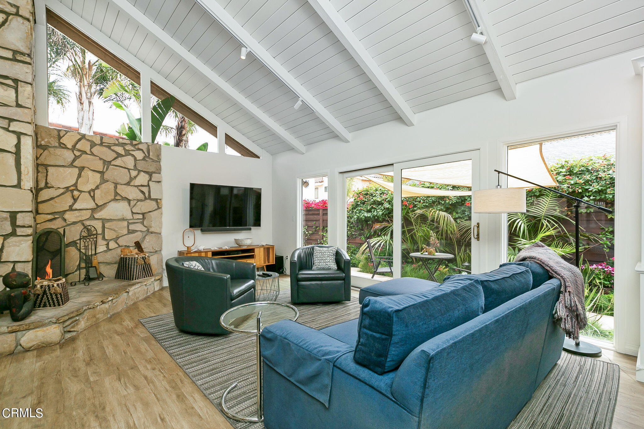 4930 Dolphin Way Oxnard, CA 93035 - Photo 9 of 44 a living room with furniture a flat screen tv and a floor to ceiling window