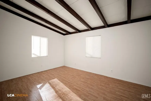 a view of a room with wooden floor and windows