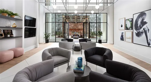 a living room with furniture and a floor to ceiling window