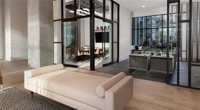 a bedroom with a bed a table and flat screen tv