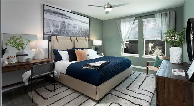 a bedroom with a large bed and a large window