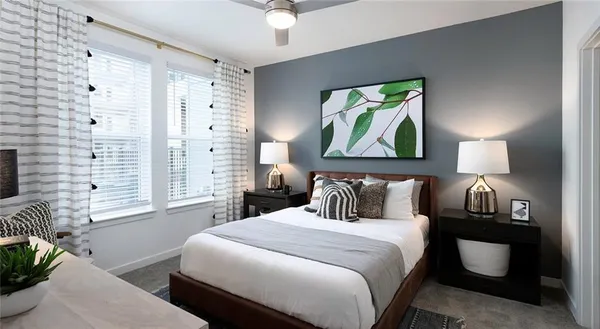 a bedroom with a bed and a painting on the wall