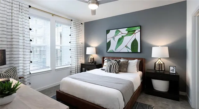 a bedroom with a bed and a painting on the wall