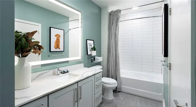 a bathroom with a granite countertop sink toilet and shower