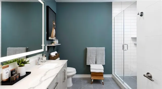 a bathroom with a sink toilet and shower