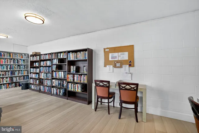 a view of a workspace with furniture and wooden floor