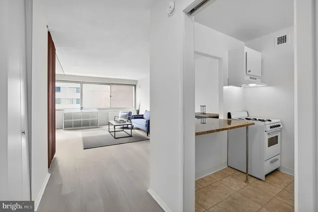 a kitchen with stainless steel appliances granite countertop a stove and more cabinets