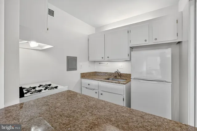 a kitchen with a stove and a refrigerator