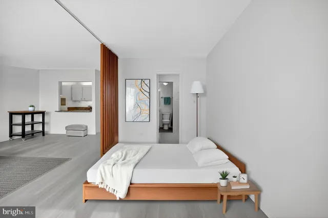 a bedroom with a bed and a table