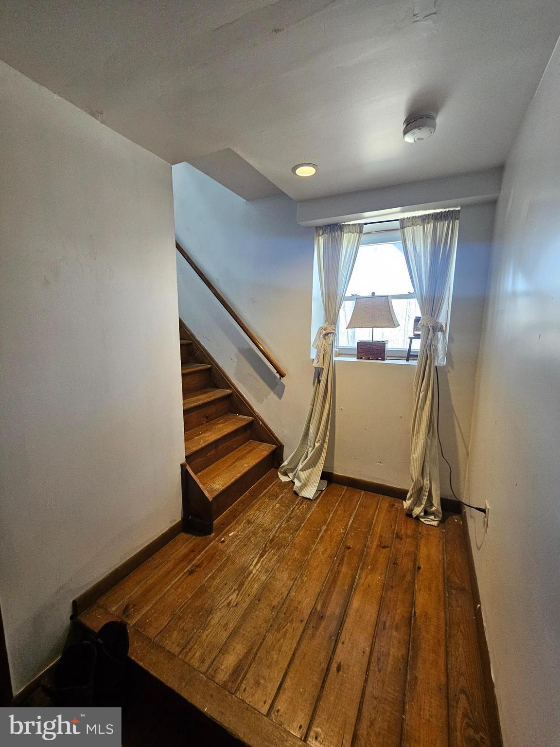 2733 Bachman Road Westminster, MD 21157 - Photo 18 of 43 a view of an empty room with wooden floor and stairs