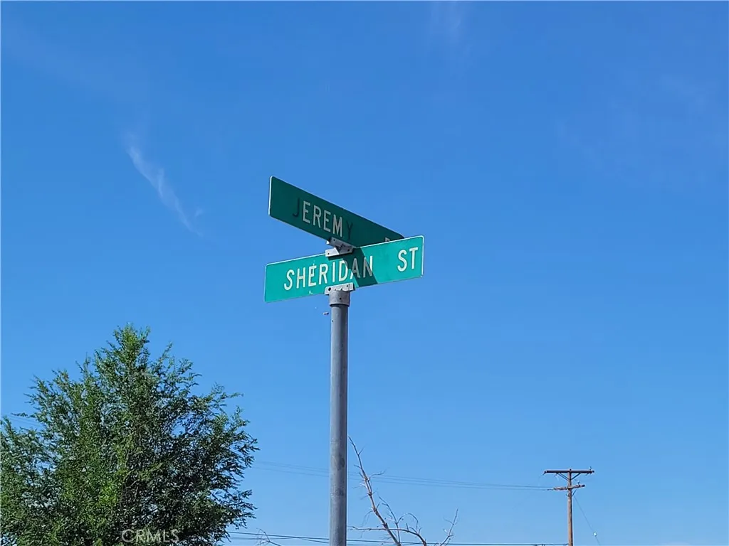 a street sign on a wall next to a blue wall