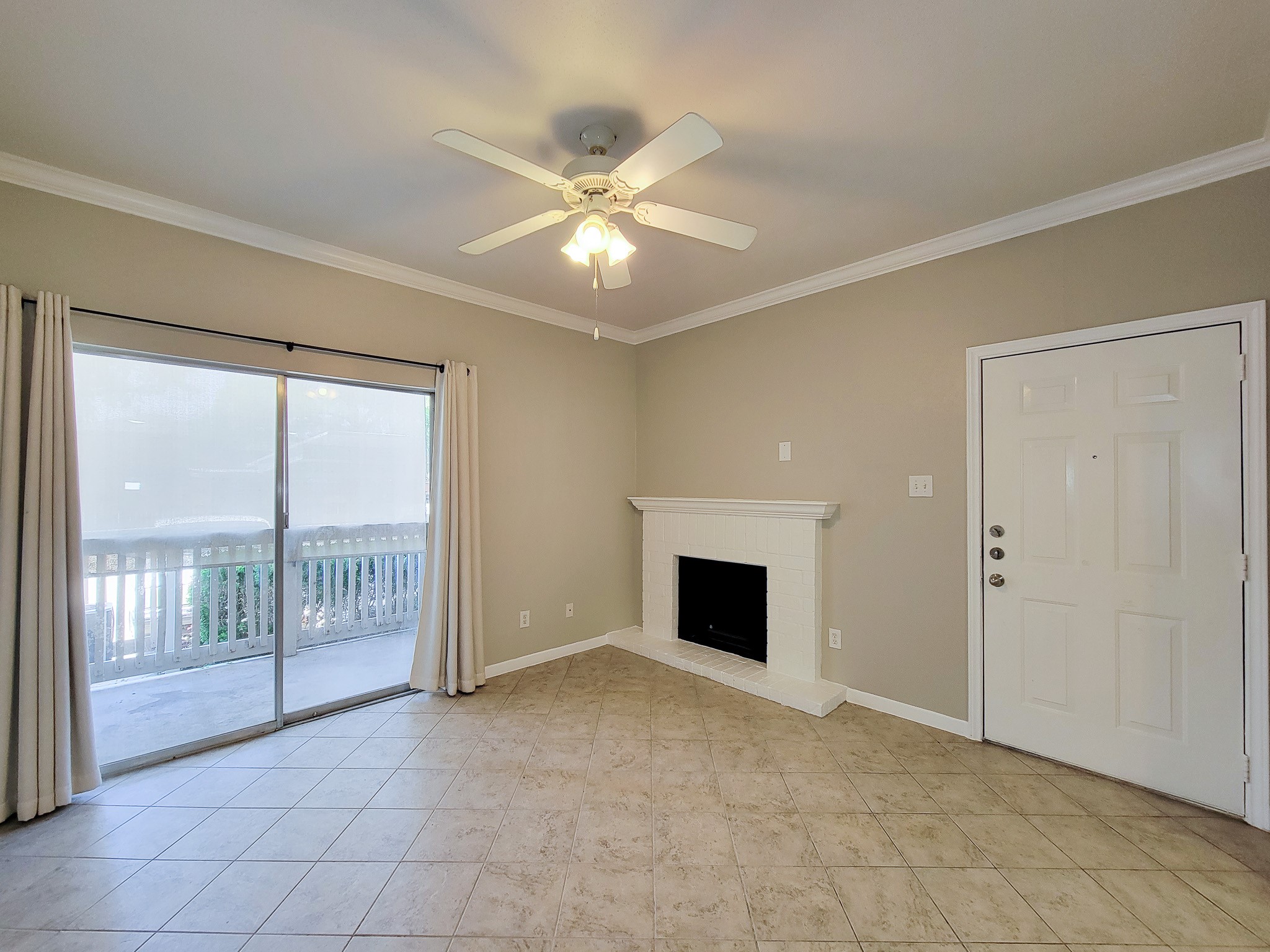 4041 Drake Street, Unit 116 Houston, TX 77005 - Photo 6 of 27 a view of an empty room with glass door and a chandelier fan