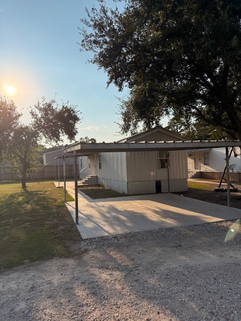 22786 Cuttler Road New Caney, TX 77357 - Photo 1 of 12 This property features a cozy mobile home with a covered carport and a spacious yard. Mature trees provide shade, and the area is well-maintained, offering a peaceful and inviting setting.