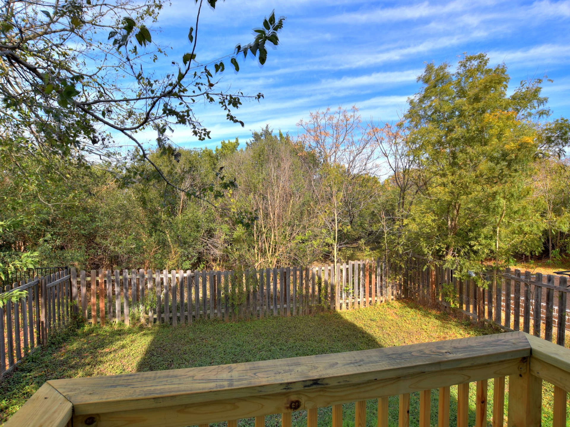 917 East 3rd Street Georgetown, TX 78626 - Photo 22 of 23 A fully fenced backyard offers private green space for outdoor activities and relaxation.