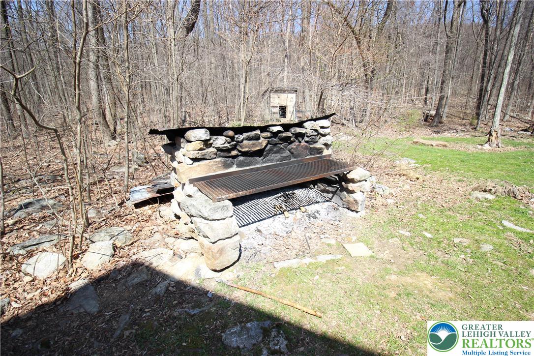 312 Old Grade Road Wind Gap, PA 18091 - Photo 47 of 54 a backyard of a house with table and chairs