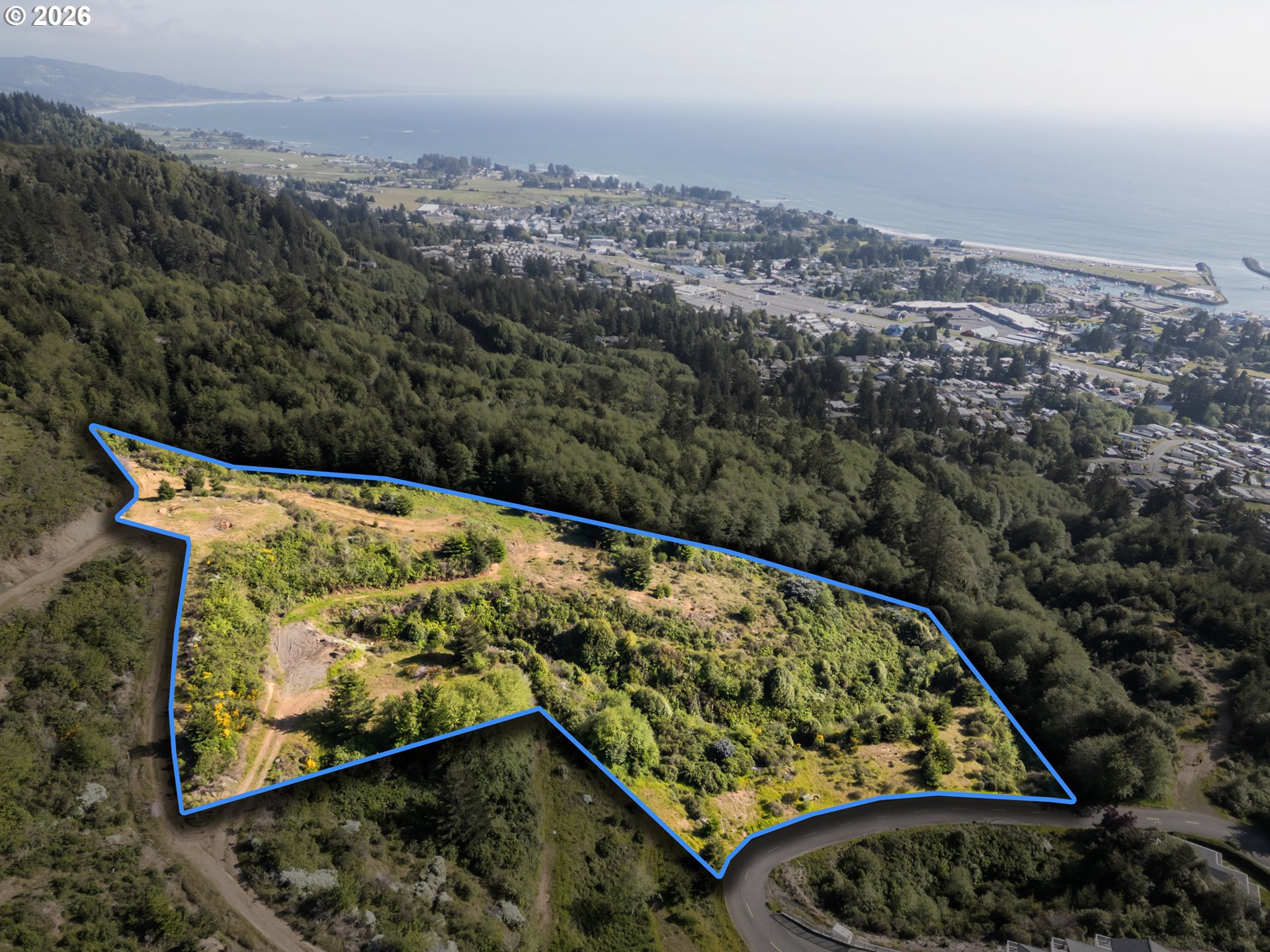 Crown Terrace Road, Unit 1 Brookings, OR 97415 - Photo 1 of 11 an aerial view of a large body of water and covered with fog