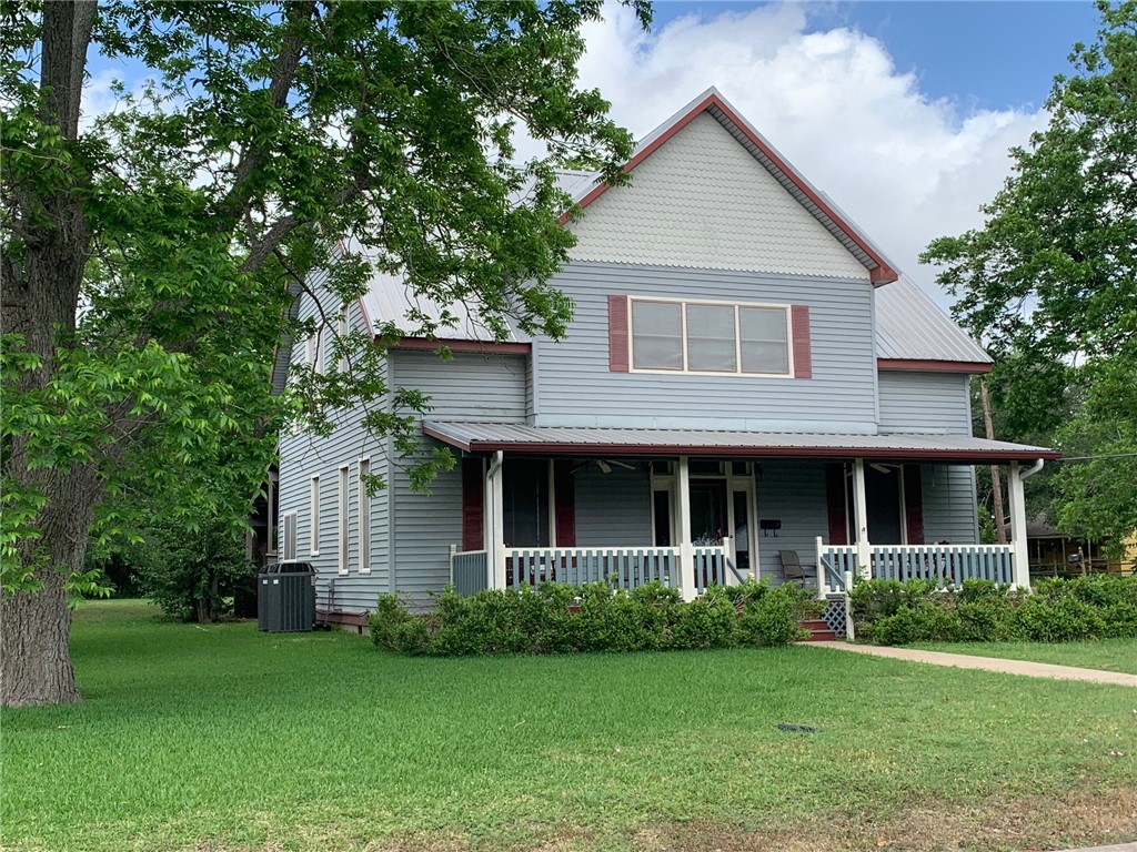 205 South Rio Grande Street Lockhart, TX 78644 - Photo 1 of 1 a front view of a house with a garden and yard