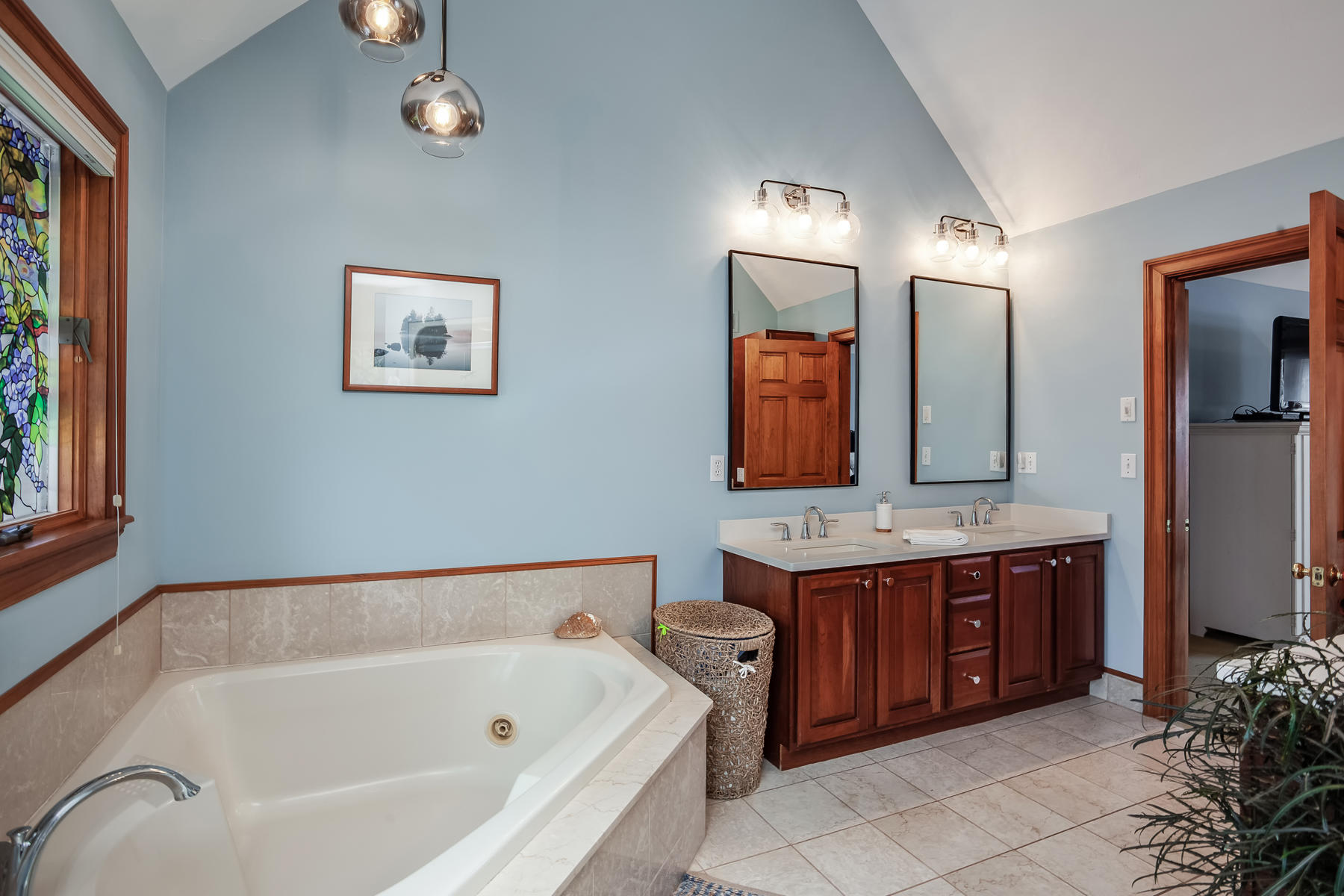 133 Summersea Road Mashpee, MA 02649 - Photo 23 of 45 a bathroom with a tub a double vanity sink and a large mirror