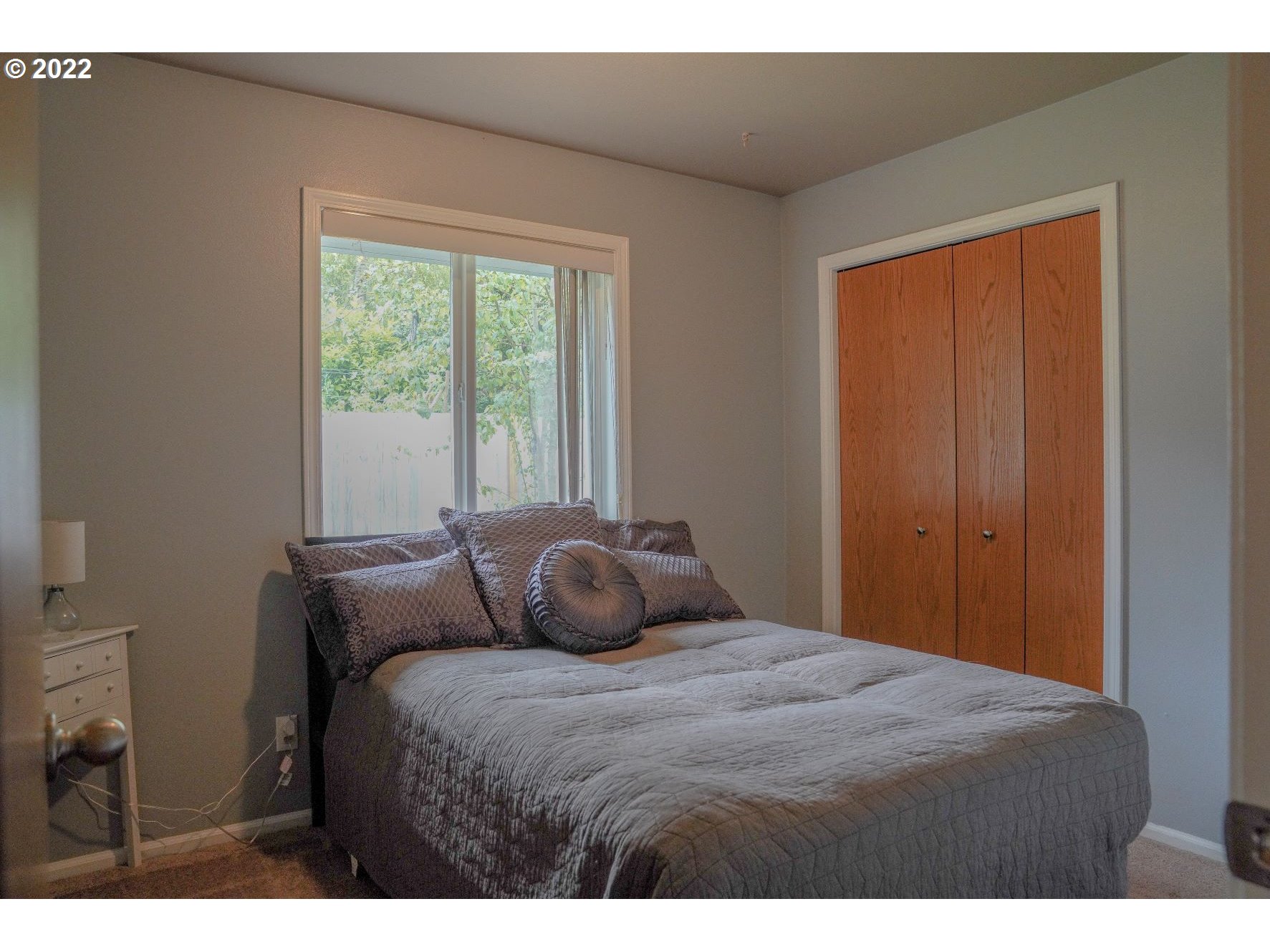 560 South 70th Street Springfield, OR 97478 - Photo 15 of 21 a bedroom with a large bed and a large window