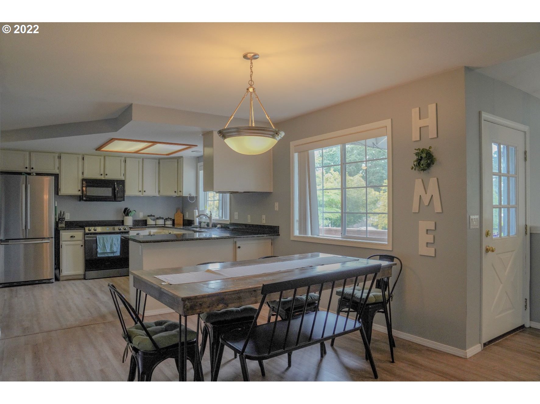 560 South 70th Street Springfield, OR 97478 - Photo 5 of 21 a kitchen with stainless steel appliances granite countertop a kitchen island hardwood floor and a sink