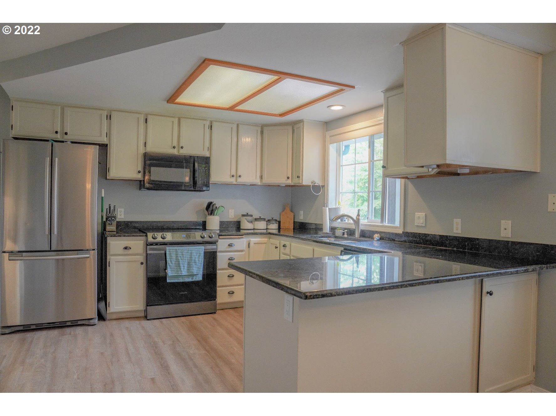 560 South 70th Street Springfield, OR 97478 - Photo 7 of 21 a kitchen with kitchen island granite countertop a sink appliances and cabinets