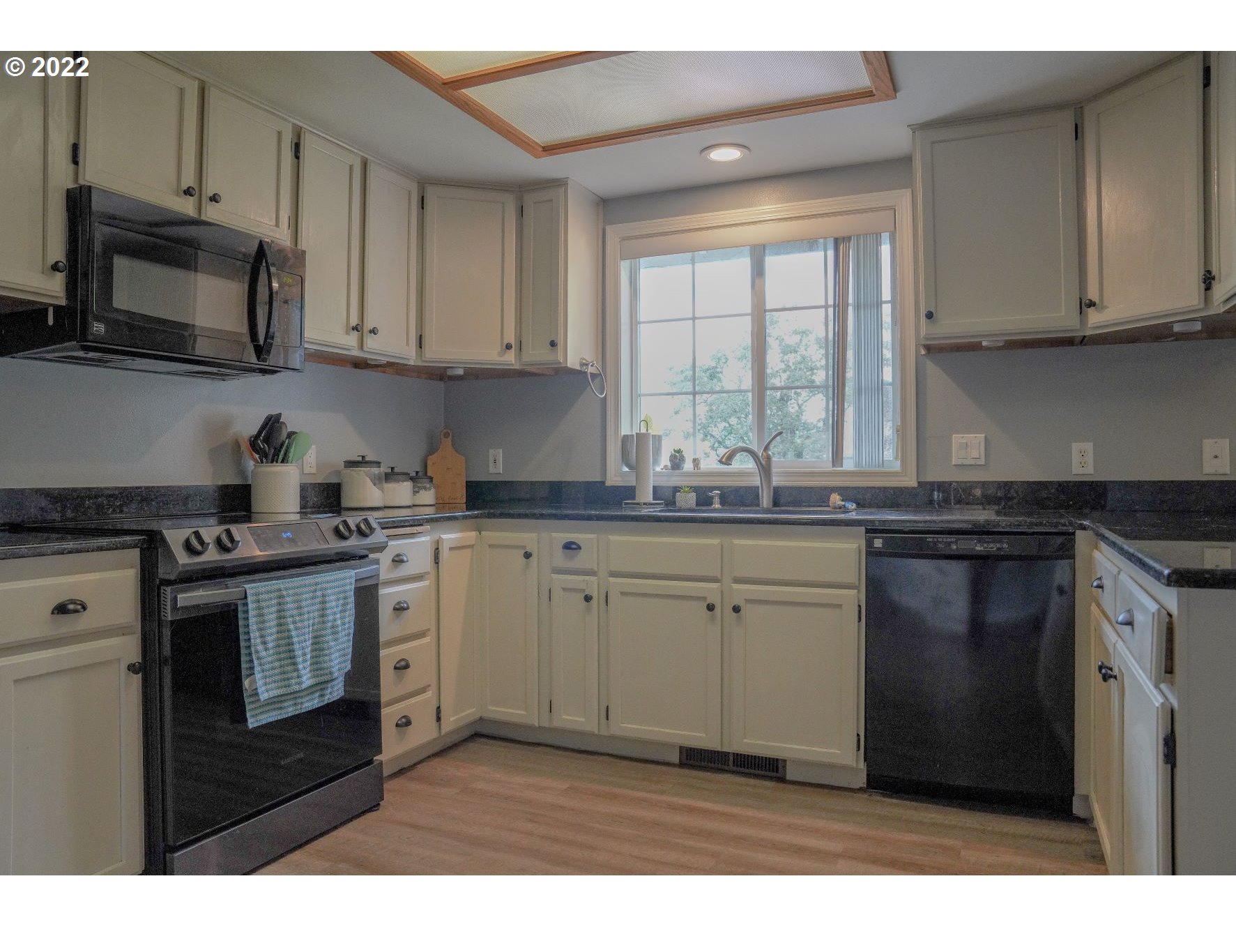 560 South 70th Street Springfield, OR 97478 - Photo 9 of 21 a kitchen with stainless steel appliances granite countertop a stove a sink and a microwave