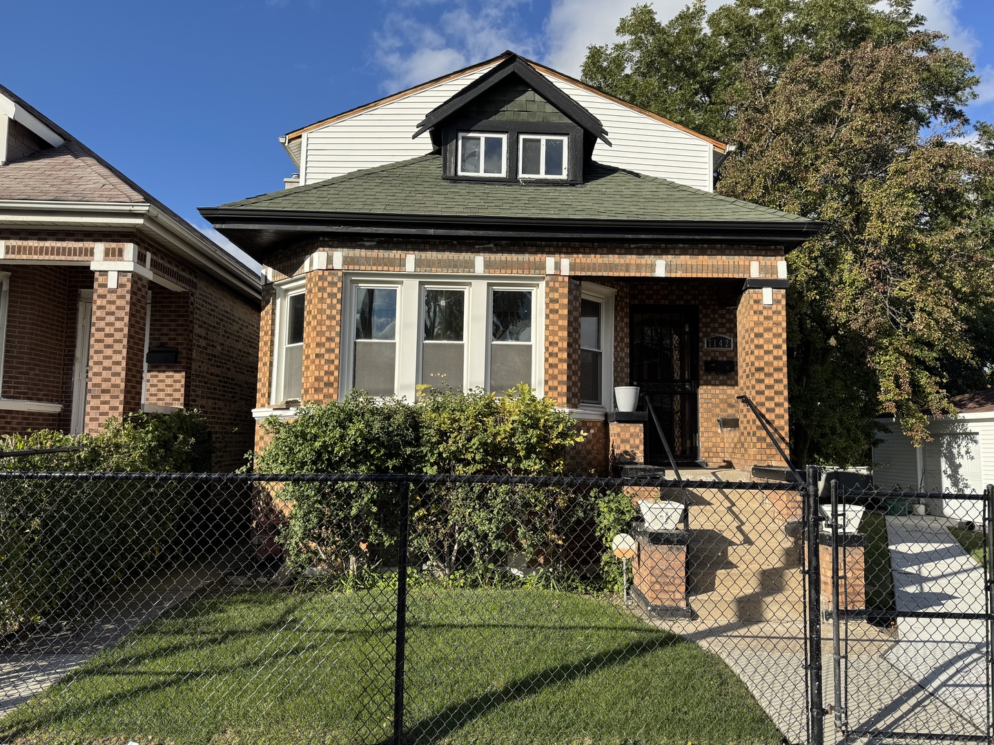 7142 South Damen Avenue Chicago, IL 60636 - Photo 1 of 20 a front view of a house with garden