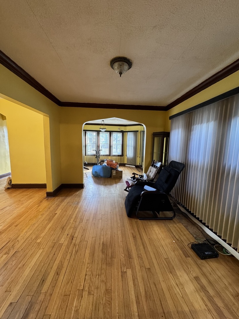 7142 South Damen Avenue Chicago, IL 60636 - Photo 3 of 20 a living room with furniture and a wooden floor