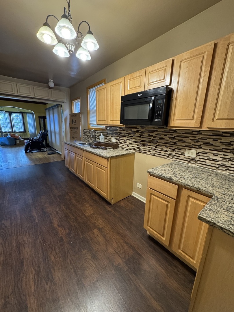 7142 South Damen Avenue Chicago, IL 60636 - Photo 6 of 20 a kitchen with lots of counter top space and appliances