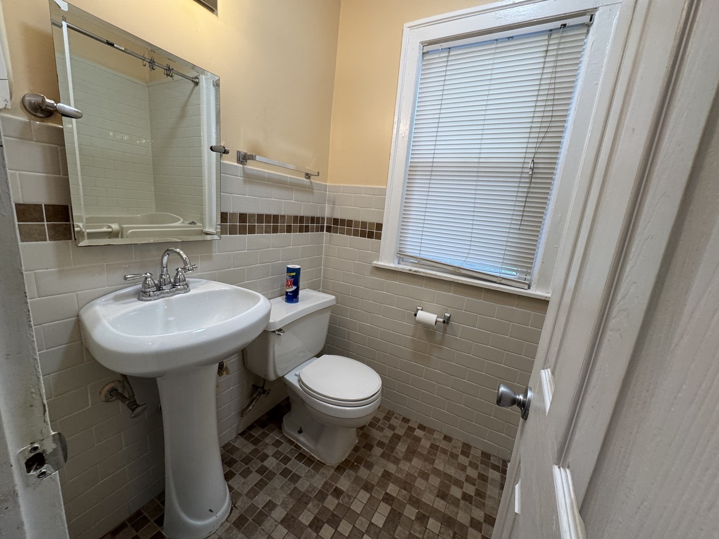 7142 South Damen Avenue Chicago, IL 60636 - Photo 8 of 20 a bathroom with a sink toilet and a mirror