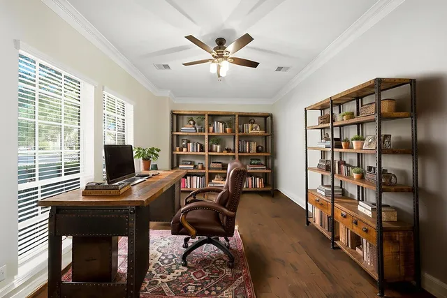 a workspace with furniture window and a ceiling fan