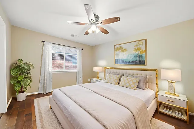 a bedroom with a large bed and a chandelier