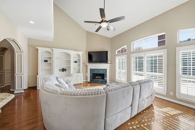 a living room with furniture fireplace and flat screen tv