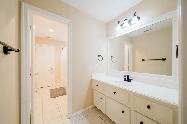 a bathroom with a double vanity sink a mirror and a shower