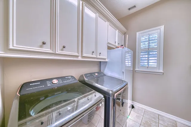 a utility room with sink dryer and washer
