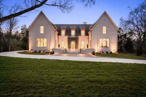 a kitchen with a stove a sink and cabinets