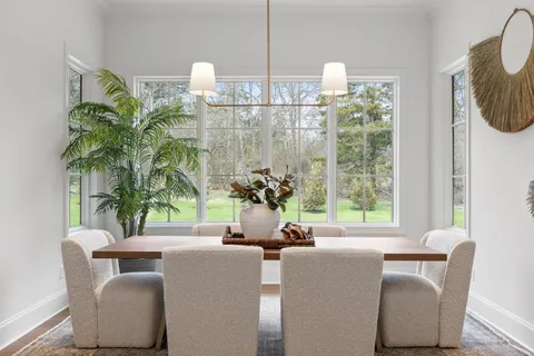 a bathroom with a sink a toilet a mirror a bathtub and shower