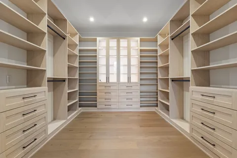 a view of a house with a big yard and large trees