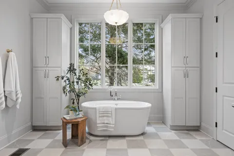 a front view of a house with a yard and trees