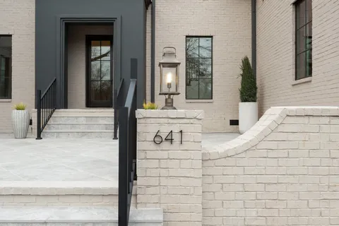a kitchen with stainless steel appliances white cabinets and a stove top oven